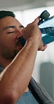 Fitness, man and drinking water after gym exercise, workout and training, cardio or routine. Hydration, drinking and male athlete with liquid break for wellness, health and athletic performance