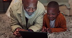 Kid, learning and grandfather with tablet in home with mobile app, education and time relax together in living room. African, senior man and teaching family with technology or bonding with games