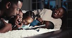 Happy, night and a black family with a tablet on the bed for tickling, playful and laughing at a show. Smile, relax and African parents with children, fun and technology in the dark for a cartoon