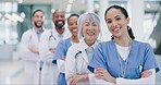 Crossed arms, group and face of doctors in hospital with confidence, leadership and happiness. Smile, diversity and portrait of a professional team of healthcare workers in hallway of medical clinic.