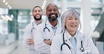 Crossed arms, team and face of doctors standing in the medical hospital with confidence. Happy, professional and portrait of group of healthcare workers with a smile in a hallway of medicare clinic.