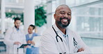 Mature black man, arms crossed and doctor, portrait and health with smile, confident and surgeon at clinic. Male physician, medical expert and cardiology specialist, healthcare and happy professional