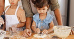 Hands, learning and parents baking with children in a kitchen table together to prepare cookies or biscuits recipe at home. Development, mother and father teaching or helping kids cooking in a house