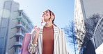 Happy woman, walking and shopping bag in city street for discount, sale or outdoor travel. Excited female person or shopper smile for purchase, buying or fashion in happiness, retail or urban town 