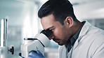 Science, research and microscope by man scientist in a laboratory for Pharma, analysis or innovation. Healthcare, analytics and guy scientific expert with data, sample or bacteria inspection in a lab