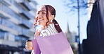 Happy woman, walking and shopping bag in city for discount, sale promotion or outdoor purchase. Rear view of female person or shopper smile in happiness, satisfaction or fashion in an urban town