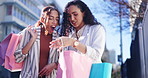 Happy woman, friends and walking with shopping bag in city together for discount, sale or outdoor purchase. Women or shopper smile in happiness for retail, deal or bonus promotion in an urban town