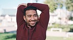 Fitness, health and man stretching arms in an outdoor park before race or marathon training workout. Nature, smile and young male runner athlete doing warm up exercise before cardio running in field.