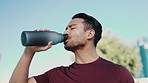 Fitness health, outdoor and man drinking water for sports thirst hydration, workout challenge or exercise running. Athlete wellness, bottle and person tired, fatigue and relax with liquid beverage