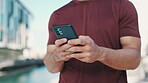 Man, phone and hands typing in city for outdoor communication, networking or online browsing. Closeup of male person chatting, texting or social media on mobile smartphone app in an urban town