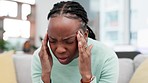 Stress, headache and black woman on a sofa with temple massage, disaster or vertigo at home. Anxiety, headache and African lady face with brain fog, depression or mental health crisis in living room