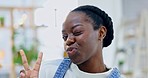 Face, blowing kiss and a black woman in a house with a peace sign, love and fun energy. Happy, young and portrait of an African girl in a home living room with a hand emoji and gesture with a smile