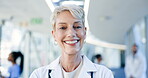 Woman, face and doctor smile in hospital for healthcare services, surgery or consulting in Australia. Portrait of happy surgeon, senior manager and medical therapist working with trust in busy clinic