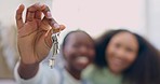 Portrait, moving and lesbian couple in new home with keys, smile and excited investment together. Real estate, love and mortgage, happy lgbt women with pride in apartment with blurred background.