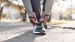 Hands, tie shoelace and start run outdoor, fitness and cardio with person ready for race or marathon in park. Sneakers, runner in nature and exercise with sports, training and prepare for workout