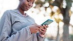 Fitness, outdoor and black woman with a smartphone, typing and connection for social media, sms and email. Person, girl or athlete in a park, cellphone or mobile app for progress tracker and training