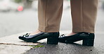 Waiting, city ground and a person with shoes on the sidewalk in the morning for work travel. Low, standing and legs or feet of people in the road for a commute, urban road or tapping for impatience