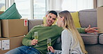 Couple, wine and talk in new home, moving to real estate investment and chat about interior design. Happy man, woman and homeowners drink champagne, speaking and celebrate mortgage loan for property 