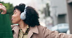 Woman, headphones and dance with shopping bags in the city, street or celebration of sales, discount and deal on clothes. Happy, customer or singing shopper walking and listening to radio song