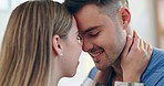 Happy, love and couple with an intimate moment in the living room of their apartment together. Happiness, bonding and young man and woman with eskimo kisses for care and affection in lounge at home.