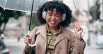 Music, headphones and black woman dance in city, street or walking with radio, song or hear techno audio. Happy, listening and person streaming hip hop, track or podcast in the rain with umbrella