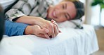 Love, happy and couple holding hands in bed talking, relax and bond in their home together. Bedroom, conversation and man with woman resting, care and speaking, smile and enjoy relationship in house