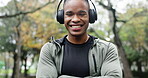 Arms crossed, fitness and music with black man in park for running, streaming and cardio. Health, exercise and workout with portrait of runner and headphones for sports, training and wellness