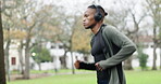 Training, running and music with black man in park for fitness, streaming and cardio. Health, exercise and workout with runner listening to headphones in nature for sports, performance and wellness