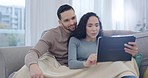 Tablet, couple and home with series and film streaming with love and care on sofa. Living room, website and watching movie online with young people together in a lounge with social media app scroll