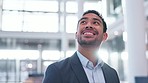 Smile, vision and a businessman in an office building for opportunity, work and a new job. Happy, corporate and a young Asian employee looking at a workplace, thinking and admiring professional space