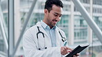 Man, tablet and a doctor walking in a hospital with internet for research, results or information. Medical staff, health care and asian person with tech for email, online consultation or telehealth