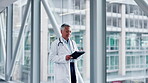 Doctor, tablet and a woman walking in a hospital with internet for research, results or information. Medical staff, health care and person with tech for management, online consultation or telehealth