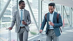 Talking, happy and men with luggage at an airport for travel and communication. Smile, diversity and an Asian man with an African person, suitcase and conversation on a journey for work together