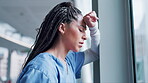 Woman, doctor and headache in stress, burnout or mistake leaning on window in hospital building. Frustrated or sad female person or medical healthcare nurse in grief, loss or failed surgery at clinic