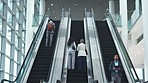 Escalator, office and business people on travel, commute and arrival in lobby for convention. Modern building, professional and men and women on electric stairs on technology for work, career and job