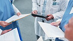 People, doctor and hands in meeting with documents or tablet for medical research or discussion at hospital. Group of healthcare workers in team planning with paperwork, results or clinic information