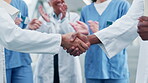 Doctor, handshake and people applause in teamwork, meeting or partnership together at the hospital. Closeup of medical or healthcare professional shaking hands and clapping in celebration or success