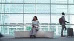 Busy airport, people and a woman with a phone for social media, communication or email check. Moving fast, sitting and a girl or person with a mobile in a lobby and waiting for a flight or chat