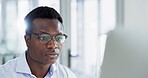 Computer, reading and business man with glasses for information, research or data analysis at office desk. Face of serious black man with technology or internet for feedback, email or problem solving