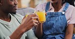 Toast, black couple and orange juice in home, happy and healthy diet, nutrition or wellness on living room sofa. Man, woman and drink cheers in fruit glass, organic vitamin c and vegan conversation