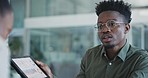African businessman, talking and tablet with data, stats and report for meeting with information on growth, profit or strategy in office. People, review and discussion with business analyst or expert