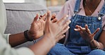 Argument, discussion and hands of couple on sofa for relationship problems, fight and conflict. Dating, communication and angry man and woman in conversation, talking and speaking for disagreement