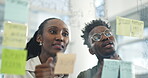 Business people, planning and schedule in team strategy or meeting on glass board at the office. African businessman and woman in team discussion, project plan or brainstorming at the workplace