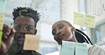 Black people, writing and planning in schedule brainstorming, strategy or ideas on glass board at office. African man and woman in team project plan, tasks or reminder on sticky note at the workplace