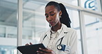 Doctor, woman and tablet in clinic for healthcare information, online charts and medical check or research. African nurse or professional scroll on digital technology for hospital schedule or results