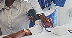 Doctor, patient and blood pressure at the hospital in healthcare appointment, checkup or consultation. Hands of medical nurse helping customer measure heart health, BPM or diabetes at the clinic