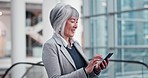 Escalator, phone and businesswoman networking in an airport on social media or the internet. Technology, professional and senior lawyer browsing on a mobile app with a cellphone in a hotel lobby.