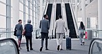 Business people, suitcase and airport escalator for talk, global travel and international flight schedule in New York. Corporate group, women and luggage by stairs, back or hotel for working holiday