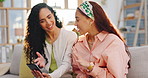 Phone, women and friends talking about social media gossip  conversation online, internet or web in a home living room. Relax, happy and girls chatting search on cellphone for funny meme on a sofa