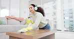 Headphone, spray and woman spring cleaning on a table in home living room as for hygiene, protection or disinfection. Dirt, dust and person or cleaner doing domestic or sanitary housekeeping work